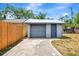 Detached garage with blue door and new roof at 609 25Th W Ave, Bradenton, FL 34205