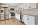 Modern kitchen featuring stainless steel appliances, a sleek faucet, and white cabinetry at 609 25Th W Ave, Bradenton, FL 34205
