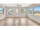 Bright Living Room featuring hardwood floors, neutral walls, white trim, and a decorative front door at 609 25Th W Ave, Bradenton, FL 34205