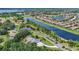 Aerial image capturing the home's lakeside setting, complemented by manicured lawns and a tranquil, community environment at 6102 9Th Avenue Cir Ne, Bradenton, FL 34212
