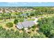 This aerial view highlights a home nestled among lush greenery with water views, showcasing its serene and private location at 6102 9Th Avenue Cir Ne, Bradenton, FL 34212