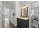 Elegant bathroom featuring a vanity with granite counters, framed mirror and dark wood floors at 6102 9Th Avenue Cir Ne, Bradenton, FL 34212