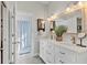 Well-lit bathroom featuring double sinks, vanity with mirror, and a shower with a curtain at 6102 9Th Avenue Cir Ne, Bradenton, FL 34212