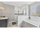 Bright bathroom with a glass-enclosed shower, soaking tub, and stylish fixtures at 6102 9Th Avenue Cir Ne, Bradenton, FL 34212