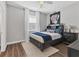 Comfortable bedroom featuring wood floors, ceiling fan, and a headboard with built in shelving at 6102 9Th Avenue Cir Ne, Bradenton, FL 34212