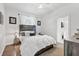 Cozy bedroom with wood floors, a ceiling fan, and a decorative headboard with integrated lighting at 6102 9Th Avenue Cir Ne, Bradenton, FL 34212