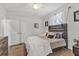 Bright bedroom with closet doors, wood floors, ceiling fan, and a decorative wood headboard at 6102 9Th Avenue Cir Ne, Bradenton, FL 34212