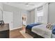 Comfortable bedroom featuring wood floors, natural light, and access to a bathroom at 6102 9Th Avenue Cir Ne, Bradenton, FL 34212