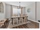 Cozy dining room with hardwood floors, chandelier, and lots of natural light at 6102 9Th Avenue Cir Ne, Bradenton, FL 34212