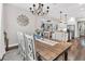 Open-concept dining area showcasing a large table with seating for six, seamlessly connected to the kitchen at 6102 9Th Avenue Cir Ne, Bradenton, FL 34212