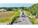 Aerial shot of a gated community entrance, surrounded by meticulously maintained landscaping and palm tree-lined roads at 6102 9Th Avenue Cir Ne, Bradenton, FL 34212