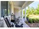 Cozy front porch featuring rocking chairs and views of the landscaped front yard at 6102 9Th Avenue Cir Ne, Bradenton, FL 34212