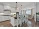 Bright kitchen with island seating, pendant lights, stainless appliances, and white cabinets at 6102 9Th Avenue Cir Ne, Bradenton, FL 34212