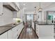 Spacious kitchen with tile backsplash, stainless appliances, and hardwood floors at 6102 9Th Avenue Cir Ne, Bradenton, FL 34212