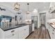 Bright kitchen island with stainless appliances, sink, and view to the living room at 6102 9Th Avenue Cir Ne, Bradenton, FL 34212