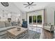 Open living room with hardwood floors, view to backyard and kitchen, ceiling fan, and natural light at 6102 9Th Avenue Cir Ne, Bradenton, FL 34212