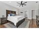 Spacious main bedroom with a dark wood bed frame, ensuite bathroom, and ample natural light at 6102 9Th Avenue Cir Ne, Bradenton, FL 34212