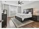 Comfortable bedroom featuring a dark wood bed frame, plush rug, and a ceiling fan for added comfort at 6102 9Th Avenue Cir Ne, Bradenton, FL 34212