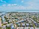 Aerial view showing a residential community, the harbor, and a glimpse of the ocean at 6250 Holmes Blvd # 63, Holmes Beach, FL 34217