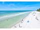 Aerial view of a beach with gentle waves and clear blue skies at 6250 Holmes Blvd # 63, Holmes Beach, FL 34217