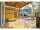 Outdoor shower and landscaped backyard with a view of a multi-story beach house with stairs at 6250 Holmes Blvd # 63, Holmes Beach, FL 34217