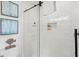 Bright bathroom shower with white subway tile, modern shower door, and a built-in niche at 6250 Holmes Blvd # 63, Holmes Beach, FL 34217