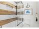 Bathroom featuring modern shower, white and wood tile, and nautical wall art at 6250 Holmes Blvd # 63, Holmes Beach, FL 34217