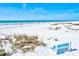 Scenic sandy beach with a bench overlooking the ocean and dunes at 6250 Holmes Blvd # 63, Holmes Beach, FL 34217