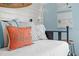 Coastal bedroom featuring a cozy daybed with decorative pillows and beach-themed artwork on light blue walls at 6250 Holmes Blvd # 63, Holmes Beach, FL 34217