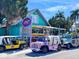 Rental business with colorful golf carts, surfboards, and other rental items, capturing a vibrant, beachy vibe at 6250 Holmes Blvd # 63, Holmes Beach, FL 34217