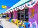Cafe with colorful tables, bakery and internet cafe services, decorated with patriotic bunting and artistic gecko at 6250 Holmes Blvd # 63, Holmes Beach, FL 34217