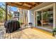 Outdoor deck with a grill, seating, and sliding doors to the home's interior space at 6250 Holmes Blvd # 63, Holmes Beach, FL 34217