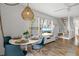 Dining area with modern chairs and view of TV, stairs, and decor at 6250 Holmes Blvd # 63, Holmes Beach, FL 34217