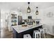 Modern kitchen with white cabinets, stainless steel appliances, and island with counter seating at 6250 Holmes Blvd # 63, Holmes Beach, FL 34217