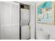 Functional bathroom laundry closet with stacked washer and dryer for efficient space saving at 6250 Holmes Blvd # 63, Holmes Beach, FL 34217