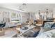 Open living area has a TV, rattan chairs, and access to the modern kitchen and dining area at 6250 Holmes Blvd # 63, Holmes Beach, FL 34217