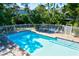Community pool featuring a brick trim, lounge chairs, tables, and an umbrella at 6250 Holmes Blvd # 63, Holmes Beach, FL 34217
