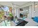 Inviting screened porch with comfortable seating and a dining area, perfect for outdoor relaxation and entertaining at 6250 Holmes Blvd # 63, Holmes Beach, FL 34217