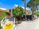 Charming yellow restaurant with a welcoming entrance, lush landscaping, and a sign indicating 'The Porch' at 6250 Holmes Blvd # 63, Holmes Beach, FL 34217