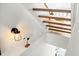 Stylish staircase featuring modern lighting and unique seagull sculpture for elegant coastal charm at 6250 Holmes Blvd # 63, Holmes Beach, FL 34217