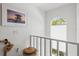 Bright staircase landing with beach themed art, arched window and stylish nautical rope at 6250 Holmes Blvd # 63, Holmes Beach, FL 34217