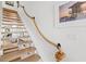 Beautiful staircase with rope railing and beach-themed artwork evokes a coastal feel at 6250 Holmes Blvd # 63, Holmes Beach, FL 34217