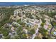 Aerial view of a charming home nestled among lush trees in a tranquil neighborhood with waterfront views at 6402 23Rd Avenue W Dr, Bradenton, FL 34209