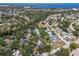 Aerial view showcases a cozy home surrounded by trees in a peaceful neighborhood near the water at 6402 23Rd Avenue W Dr, Bradenton, FL 34209