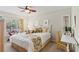 Bright bedroom showcasing a tropical-themed design, cozy bedding, and a ceiling fan at 6402 23Rd Avenue W Dr, Bradenton, FL 34209