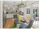 Bright dining area with glass top table, a chandelier, and view into the outdoor patio at 6402 23Rd Avenue W Dr, Bradenton, FL 34209