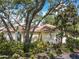 A home nestled among mature trees, showcasing a serene setting and landscaped surroundings at 6402 23Rd Avenue W Dr, Bradenton, FL 34209