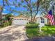 Charming home featuring a manicured front lawn, brick driveway, and welcoming curb appeal at 6402 23Rd Avenue W Dr, Bradenton, FL 34209