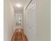 Clean hallway featuring wood floors, neutral paint, and access to other rooms at 6402 23Rd Avenue W Dr, Bradenton, FL 34209