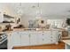 Open concept kitchen with an island, granite countertops, and pendant lighting at 6402 23Rd Avenue W Dr, Bradenton, FL 34209
